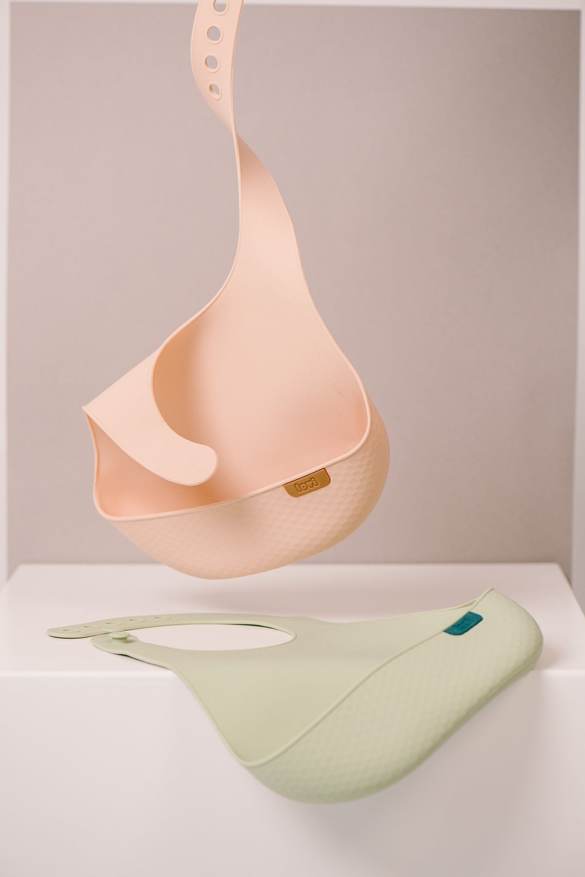 Difrax Lovi Silicone Bib Nude Hanging & Pistachio on Table