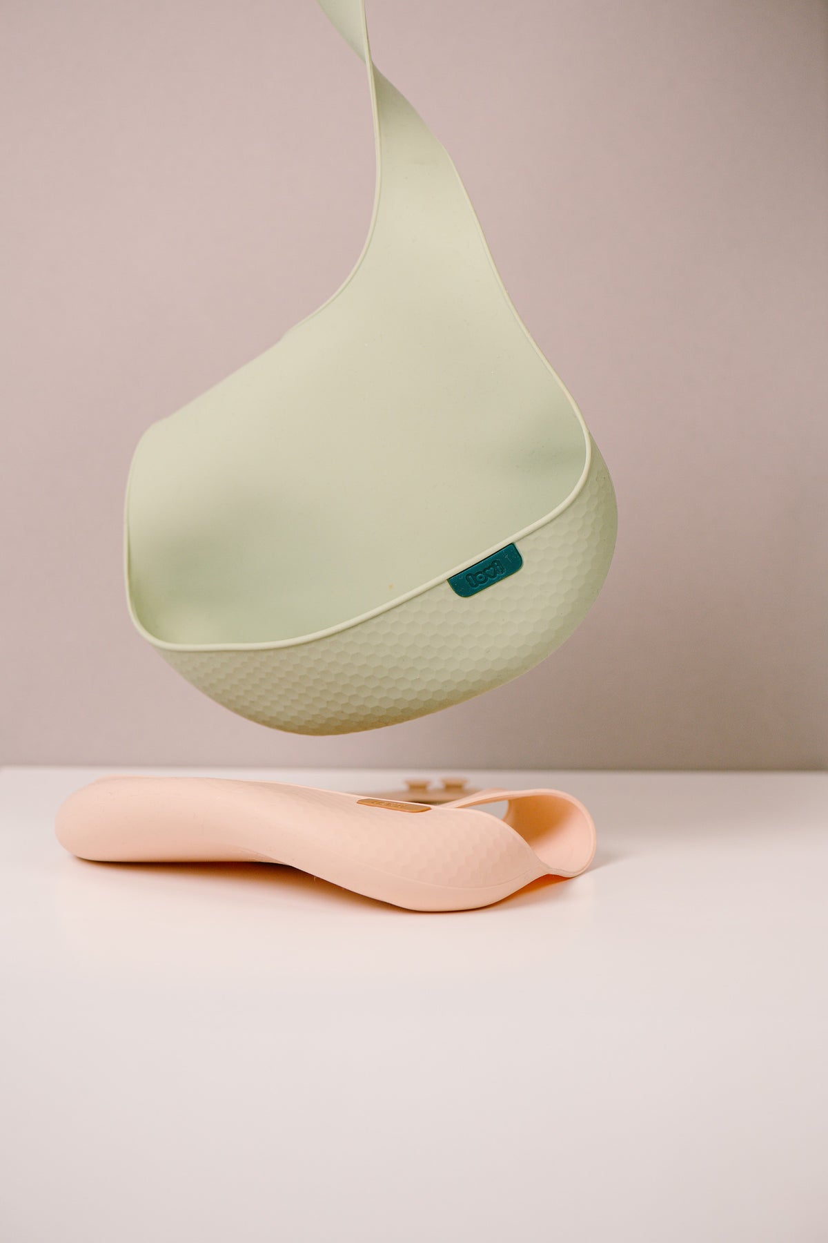 Difrax Lovi Silicone Bib Pistachio Hanging & Nude on Table