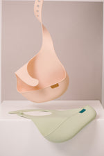 Difrax Lovi Silicone Bib Nude Hanging & Pistachio on Table
