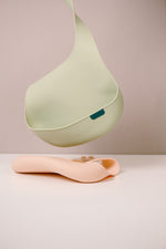 Difrax Lovi Silicone Bib Pistachio Hanging & Nude on Table