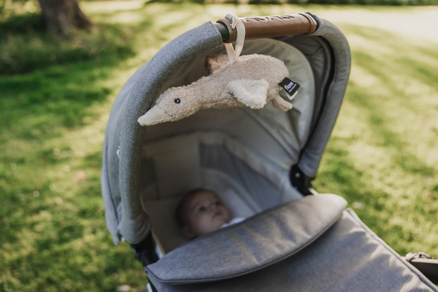 Liva Heartbeat Comforter OTG - Tied to Pram with Baby - Oat